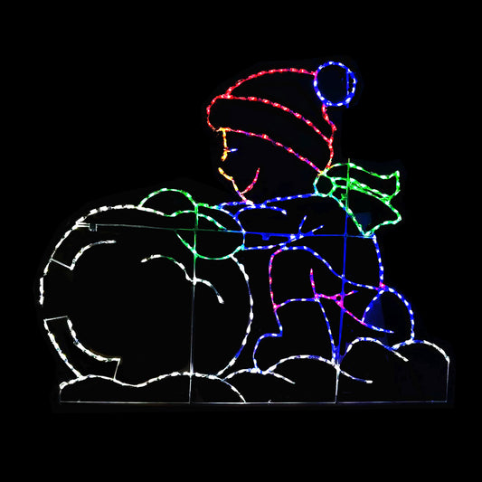 A holiday light display featuring a colorful silhouette of a child wearing a hat and scarf, rolling a snowball