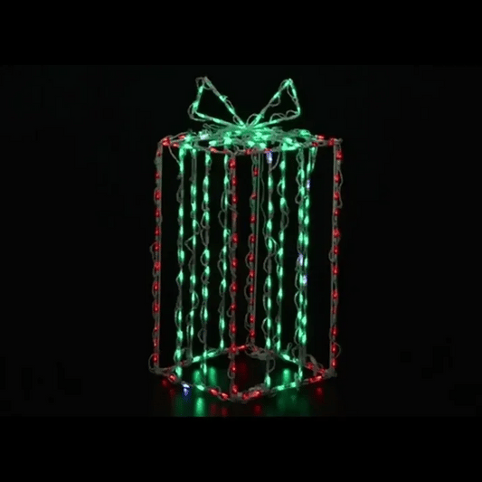 A three-dimensional gift box-shaped LED light decoration with glowing green, red, and white lights on a black background.