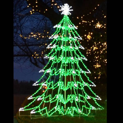 LED 3D Tree 10 ft. installed outdoors at night, full 360-degree green and white LED cone tree with layered branches and white starburst star topper, surrounded by warm white string lights in trees

